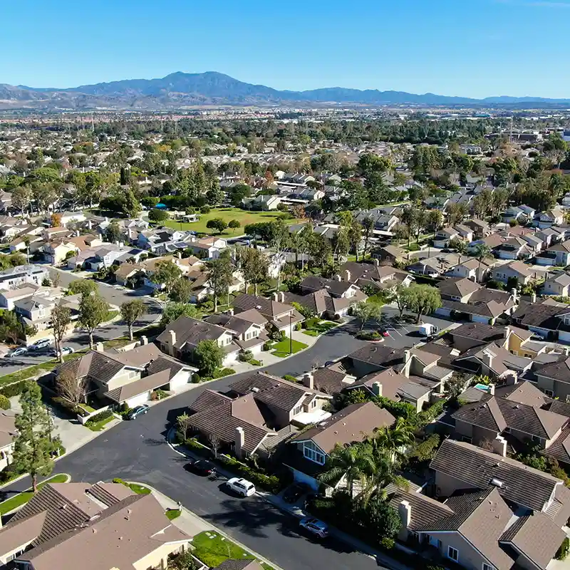 Aerial view of suburb neighborhoods in California with mountains in the background